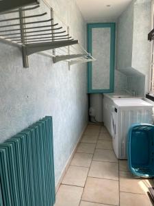 a laundry room with a washing machine and a staircase at maison de ville dans le perche in Senonches +15 photos