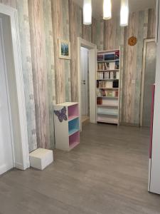 a room with bookshelves and a room with a book shelf at maison de ville dans le perche in Senonches