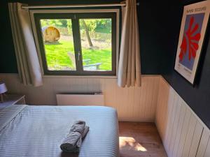 a bed in a small room with a window at Lesse toi aller in Dinant