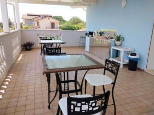a patio with tables and chairs and a pool at La Dolce Vita in Colonnella