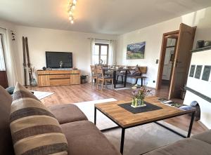 a living room with a couch and a table at Ferienwohnung Heidi mit Oberstaufen PLUS in Oberstaufen
