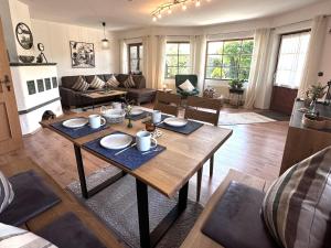 a living room with a table and a couch at Ferienwohnung Heidi mit Oberstaufen PLUS in Oberstaufen