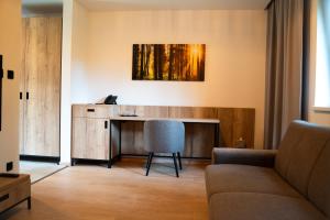 a living room with a desk and a couch at PÚŠŤ rekreačné stredisko in Prievidza +45 photos