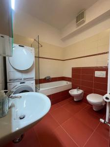 a bathroom with a sink and a toilet and a tub at Koper Sea Apartment in Koper +7 photos