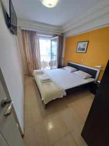 a bedroom with a bed and a window at Utopia Apartments Ohrid in Ohrid
