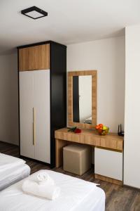 a bedroom with two beds and a mirror at Ragusa Villa in Stolac