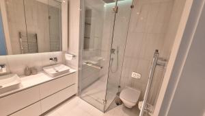 a bathroom with a shower and a toilet and a sink at Del Mar 2 Bedroom Deluxe Seaside 'A' Residence in Limassol +10 photos