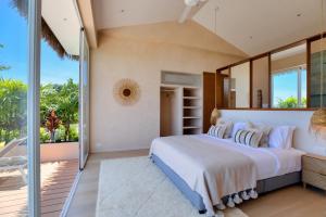 a bedroom with a large bed and a balcony at Palm Tree Seaview Villa in Koh Samui  +39 photos
