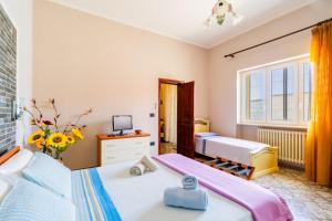 a small bedroom with two beds and a tv at Casa Venere&Aurora Luxury Apartments in Giuggianello +33 photos