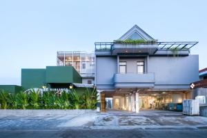 a blue building with a balcony on top of it at Omni Rooms by Sinergi in Semarang