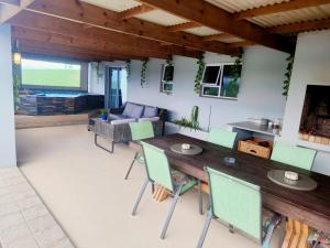 a living room with a wooden table and chairs at Bella Vista at Village-Living in Koringberg