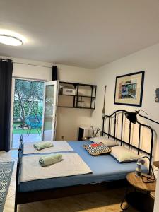 a bedroom with two beds and a door to a yard at Apartments Eti in Bol