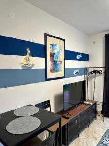 a dining room with a table and a tv at Apartments Eti in Bol