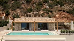 a villa with a swimming pool and a house at the Wildt - Exclusive Coastal Living in Argostoli