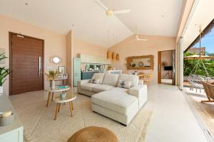 a living room with a couch and a table at Palm Tree Seaview Villa in Koh Samui 