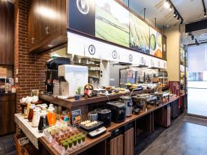 a kitchen with a counter with food on it at APA Hotel Yodoyabashi Kitahama Ekimae in Osaka