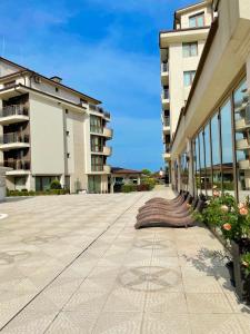 an empty sidewalk in front of a building at Long Sunny Holiday in Shkorpilovtsi