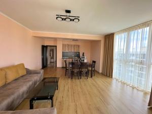 a living room with a couch and a table at Long Sunny Holiday in Shkorpilovtsi