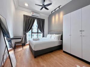 a bedroom with a bed and a dresser and a window at The Platino Skudai Johor Bahru in Johor Bahru +120 photos