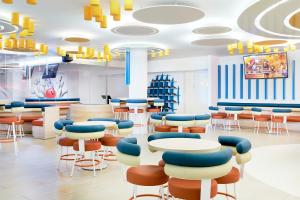 a waiting room with tables and chairs at Iberostar Waves Playa Gaviotas All Inclusive in Morro del Jable