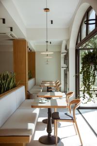 a row of tables and chairs in a restaurant at Akti Hotel Kavala in Paleo Tsifliki