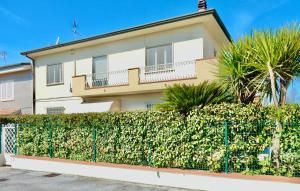 a house with a fence in front of it at Villa La Palma in Camaiore
