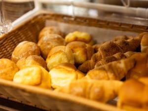a bunch of donuts in a display case at APA Hotel Yodoyabashi Kitahama Ekimae in Osaka