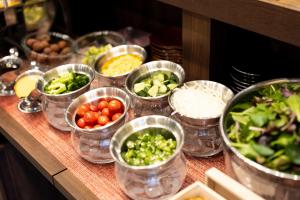 a bunch of containers of vegetables on a table at APA Hotel Yodoyabashi Kitahama Ekimae in Osaka