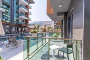 a view of the pool from the balcony of a building at Silence Garden Suite bir yatak odalı daire in Alanya