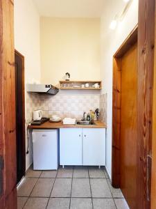 a small kitchen with white cabinets and a sink at Three Brothers in Mandrákion +28 photos