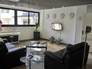 sala de estar con 2 sofás y TV en Cristal Palace Hotel, en Andria