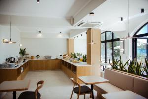a kitchen and dining room with tables and chairs at Akti Hotel Kavala in Paleo Tsifliki