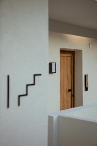 an empty room with a staircase and a door at Akti Hotel Kavala in Paleo Tsifliki