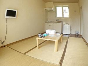 a room with a table and a tv on the wall at Cha Villa in Zamami +11 photos