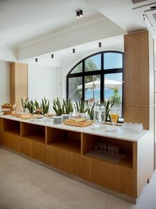 a kitchen with a large counter with food on it at Akti Hotel Kavala in Paleo Tsifliki