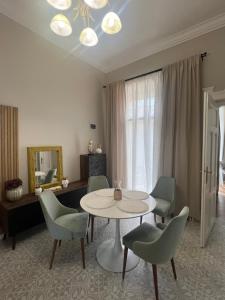 a living room with a table and chairs at La Strada Central Apartament in Oradea