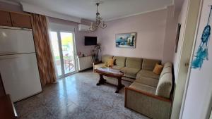 a living room with a couch and a table at LY apartment in Kallithea Halkidikis