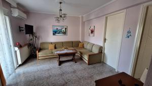 a living room with a couch and a table at LY apartment in Kallithea Halkidikis +11 photos