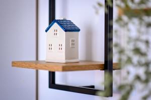 a small model of a house on a shelf at Urban Elegance - Stylish Central Accommodation in Bucharest