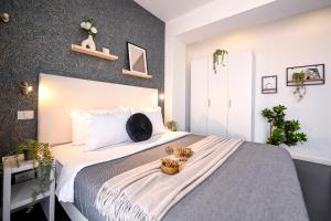 a bedroom with a bed with a cat sitting on it at Urban Elegance - Stylish Central Accommodation in Bucharest