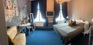 a bedroom with a bed and a sink and windows at Järnvägshotellet Skara City stay in Skara