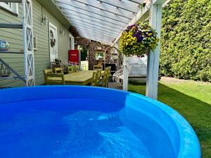 a blue hot tub in the backyard of a house at Private Villa with sauna, hot tub, playground and outside lounge area in Pärnu