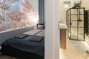 a bedroom with a bed and a bathroom with a sink at D52 Luxury Suite in Budapest