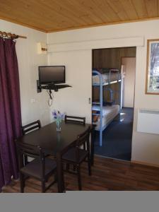 a living room with a table and a bunk bed at Launceston Holiday Park Legana in Legana