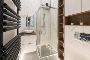 a glass shower in a bathroom with a sink at D52 Luxury Suite in Budapest +22 photos