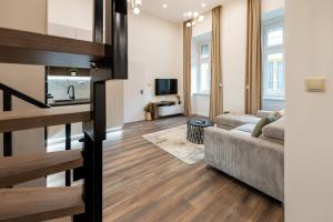 a living room with a couch and a television at D52 Luxury Suite in Budapest