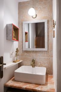 a bathroom with a sink and a mirror at Οdyssey Apartments Lefkas Centrum in Lefkada +27 photos