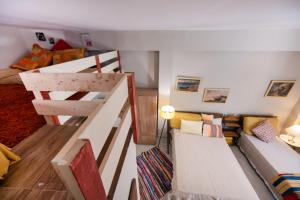 a room with two bunk beds and a couch at Οdyssey Apartments Lefkas Centrum in Lefkada