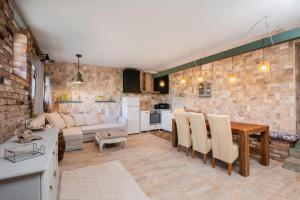 a kitchen and living room with a table and a couch at Terra Apart in Sinemorets