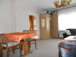 a room with a table and chairs and a living room at Ferienwohnung in Usedom Town